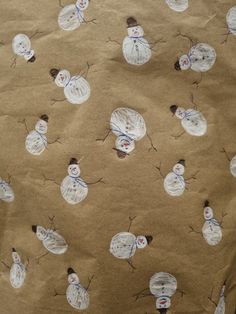 a brown paper bag with snowmen drawn on it