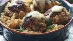 some meatballs and rice in a bowl on a table