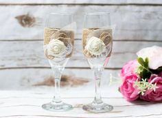 two wine glasses decorated with burlocks and flowers