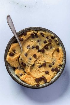 a bowl filled with ice cream and chocolate chip cookies on top of white countertop