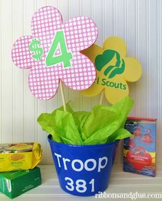 a potted plant sitting on top of a table next to some cards and books