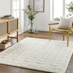 a living room with white carpet and wooden furniture