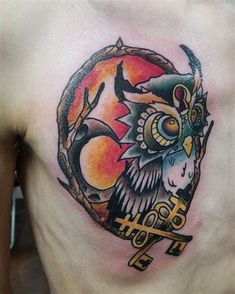 an owl tattoo on the side of a man's chest