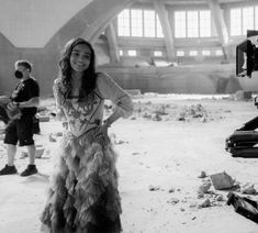 black and white photograph of a woman standing in an abandoned building