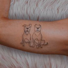 two dogs tattoo on the right arm and left arm, with one dog sitting next to another