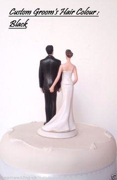 a bride and groom figurine standing on top of a white cake with the words custom groom's hair color black