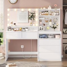 a white desk topped with lots of drawers under a wall mounted clock next to a window