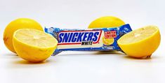 three lemons and a snack bar on a white background with the word snukers printed on it