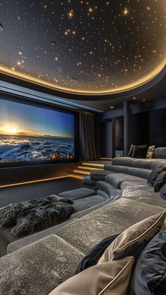 a home theater with stars on the ceiling and couches in front of the screen