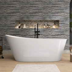 a white bath tub sitting on top of a hard wood floor next to a wall