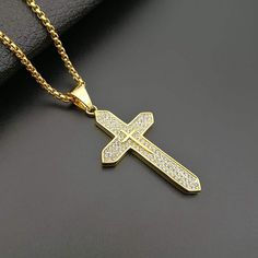 18K Gold Plated Cross Necklace Stunning 18K Gold Plated Design: Elevate your style with our non-tarnish, gold-plated Catholic box chain necklace, radiating elegance and durability. Superior Craftsmanship: Our expertly designed Catholic necklace features intricate detailing and a durable 18K gold plating that resists fading and discoloration. Compact and Stylish Design: This pendant features a sleek 68x32cm cross with a slender 3mm width, complemented by a 60cm chain for a modern and elegant look Gold Cubic Zirconia Cross Pendant Necklace, Gold Cubic Zirconia Jewelry With Box Chain, Gold Cross Necklace With Cubic Zirconia, Gold Jewelry With Vvs Clarity Cross Pendant, Gold Vvs Clarity Cross Pendant Jewelry, Gold Cubic Zirconia Box Chain Necklace, Catholic Cross, Catholic Necklace, Pendant Making