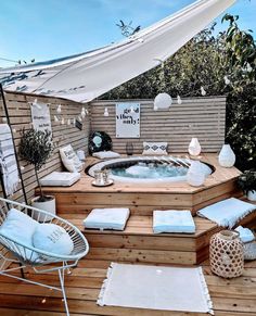 a hot tub sitting on top of a wooden deck