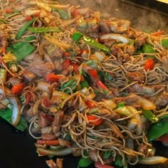 stir fry with meat and vegetables being cooked