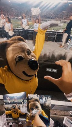 a person in a yellow shirt is holding up their hand and wearing a dog costume