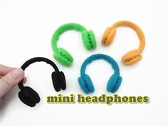 three different colored headphones sitting next to each other