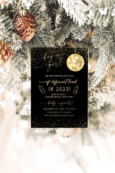 a black and gold new year's eve party card on a christmas tree