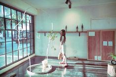 a girl is standing in an empty room