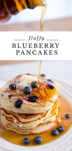 blueberry pancakes with syrup being poured onto them and topped with fresh blueberries on the side