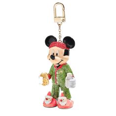 a mickey mouse keychain holding a cookie and a baguette in it's hand