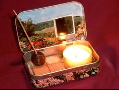 an open tin box with a candle inside