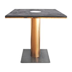 a black and gold table with a hole in the center on a square base, against a white background