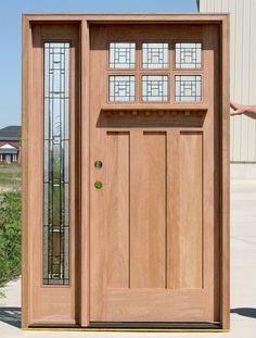 a wooden door with glass inserts on the side