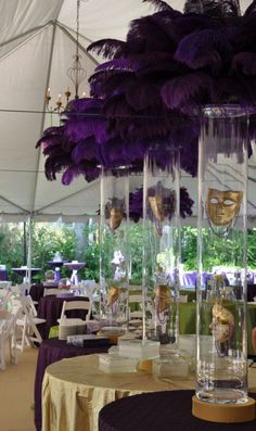 the tables are set up with purple and gold decorations for masqueradee party