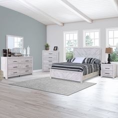 a bedroom scene with focus on the bed, dressers and mirror in the room