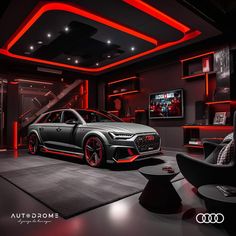 an audi car is parked in front of a tv screen and red lights on the ceiling