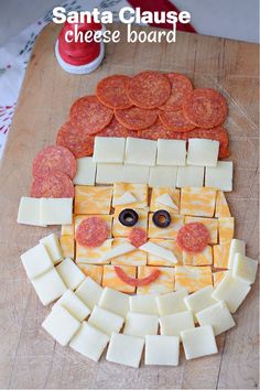 a wooden cutting board topped with sliced cheese and slices of pepperoni next to a face made out of cheese