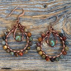 Red Creek Jasper and Czech Glass Hoop Dangle Earrings wrapped with copper wire and includes a Nickel Free Ear-Wire: These earrings are light weight, comfortable, simple and fun. Throw them on with any outfit and they will definitely add some pop They are approximately 2 inches in length and 1.25 inches at the widest portion.  All of these items are handmade so please allow for possible slight variance in sizing. If you would like these in a different color or size, please let me know as I also d Jewelry Rustic, Boho Hoop Earrings, Earthy Jewelry, Indie Jewelry, Earrings Stone, Handmade Wire Jewelry, Earrings Hoop