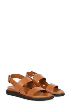 A rich leather upper adds timeless sophistication to strappy sandal fitted with an adjustable slingback strap for a customized fit. 1 1/4" heel Adjustable slingback strap with buckle closure Leather upper and lining/rubber sole Imported Brown Leather Slingback Sandals With Tang Buckle, Formal Leather Slingback Sandals With Adjustable Straps, Brown Slingback Sandals With Adjustable Strap, Brown Strappy Slingback Sandals With Adjustable Strap, Classic Strappy Sandals, Classic Leather Slingback Sandals With Ankle Strap, Classic Leather Slingback Sandals With Buckle Closure, Classic Leather Ankle Strap Slingback Sandals, Classic Open Toe Slingback Pumps With Buckle