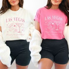 two women wearing las vegas t - shirts and shorts