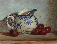 an oil painting of cherries in a blue and white pitcher on a wooden table