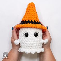 someone is holding up a crocheted halloween ghost