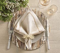 a place setting with napkins and silverware