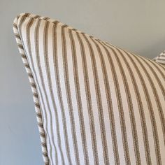 a striped pillow is sitting on the floor