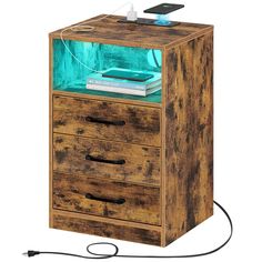 a wooden box with two drawers and an electronic device on top that is plugged in