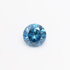 a blue diamond sitting on top of a white surface