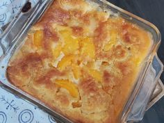 a casserole dish with peaches in it on a blue and white tablecloth