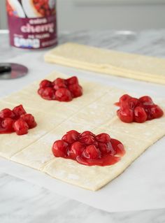 the dough is covered with red jelly and ready to go into the oven