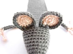 a crocheted mouse with ears on it's head is shown from above