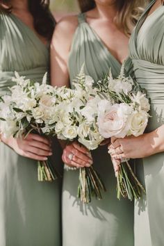 the bridesmaids are holding their bouquets together