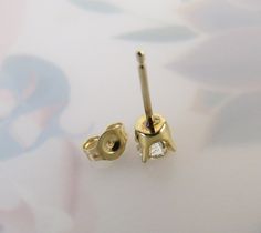 "This listing is for 1 (SINGLE) Vintage diamond 14k yellow gold stud post earring. It is perfect for the person who wears only one earring on one side or has multiple piercings on their ear or ears. A certified gemologist verbally verified the diamond as genuine and graded it with an SI2 (si2) clarity and I-J color. The 3.70mm round brilliant-cut gem has an approximate weight of .20 carat. It has a nice sparkle to it and four sturdy prongs hold it tightly in the 14k yellow gold crown style setti Classic 14k Stamped Diamond Earrings, Classic 14k Diamond Earrings, White Gold Diamond Earrings Stamped 14k, 14k Stamped Diamond Earrings For Anniversary, 14k Gold Diamond Earrings With Single Diamond, Gold 14k Single Diamond Earrings, Gold Diamond Earrings With Single Diamond In 14k Gold, Round Yellow Gold Diamond Earrings, Yellow Gold Diamond Earrings For Pierced Ears