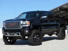 a black truck parked in front of a building