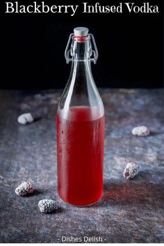 a bottle of blackberry infused vodka on a table with berries around it and the words blackberry infused vodka written below