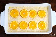 orange slices are arranged on top of rice in a casserole dish, ready to be eaten