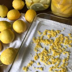 there are lemons and other fruits on the table next to some baking pans