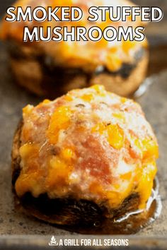 two stuffed mushrooms with melted cheese on top and the words smoked stuffed mushrooms above them