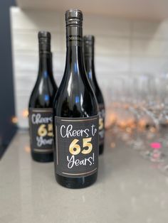 three bottles of wine sitting on top of a counter